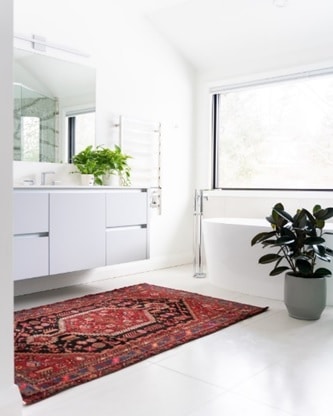 A white bathroom with a floating sink