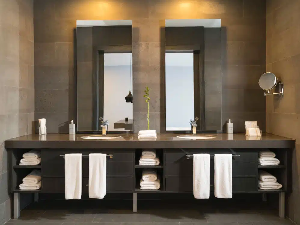A modern bathroom with a vanity and towels.